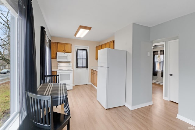 kitchen featuring white appliances and light wood-type flooring