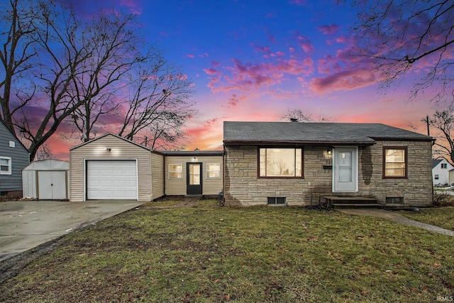 view of front of house featuring a storage unit, a yard, and a garage