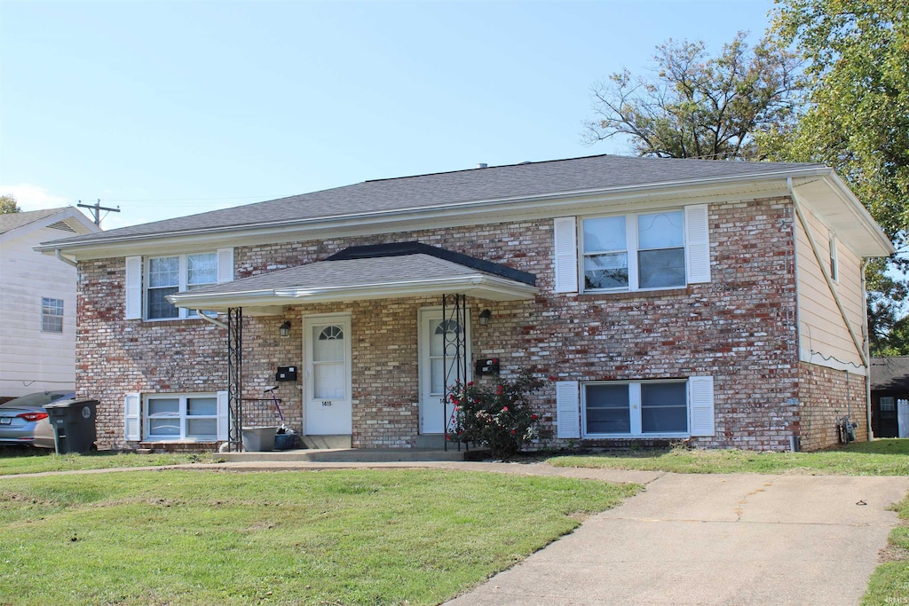 split level home featuring a front lawn and a porch