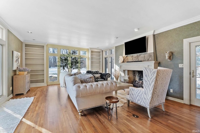 living room with crown molding, built in features, and hardwood / wood-style flooring