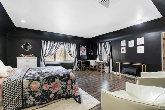 bedroom with dark hardwood / wood-style floors