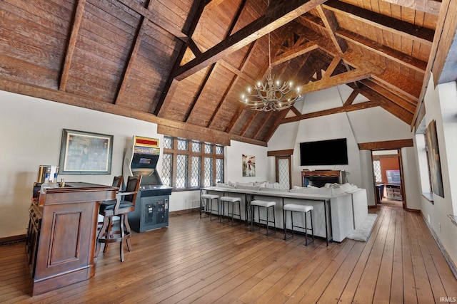 interior space featuring hardwood / wood-style flooring, high vaulted ceiling, wooden ceiling, and an inviting chandelier