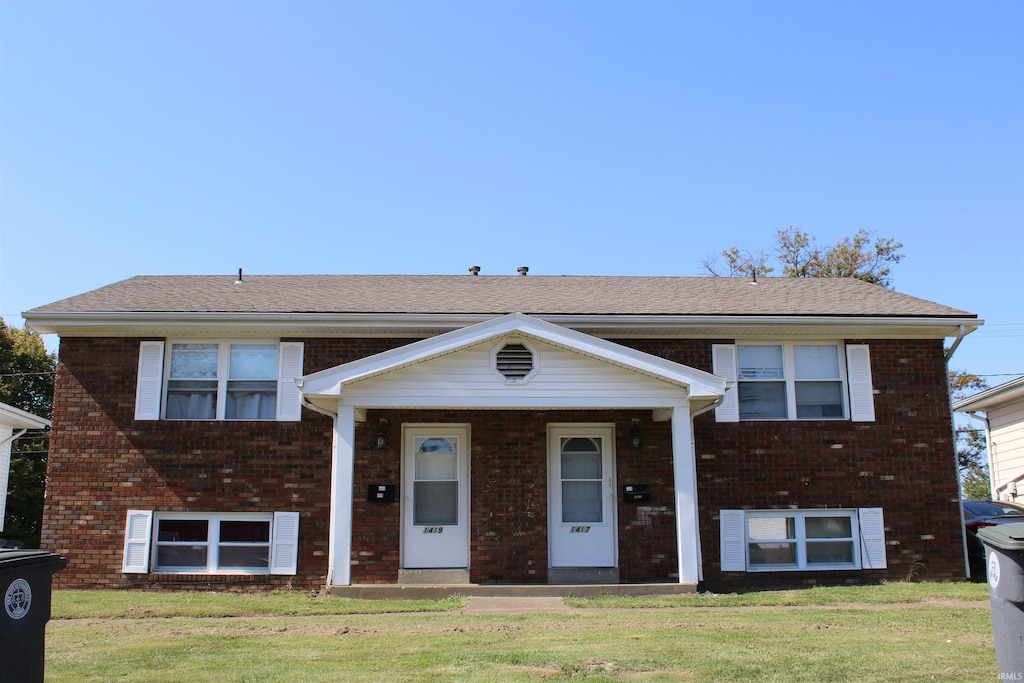 bi-level home with a front lawn