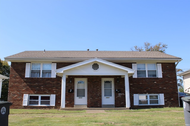 bi-level home with a front lawn