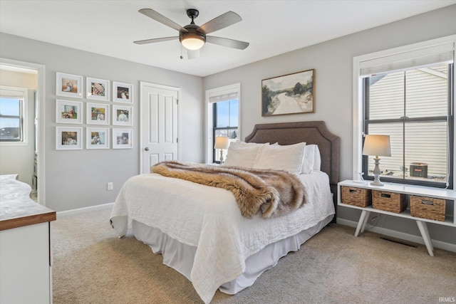 carpeted bedroom featuring multiple windows, a closet, and ceiling fan