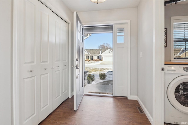 entrance foyer with washer / dryer and dark hardwood / wood-style floors