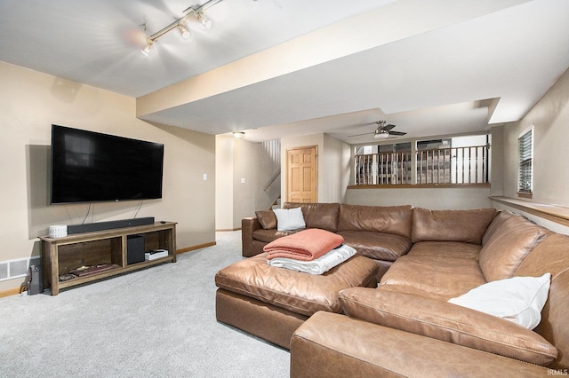 carpeted living room with ceiling fan and rail lighting