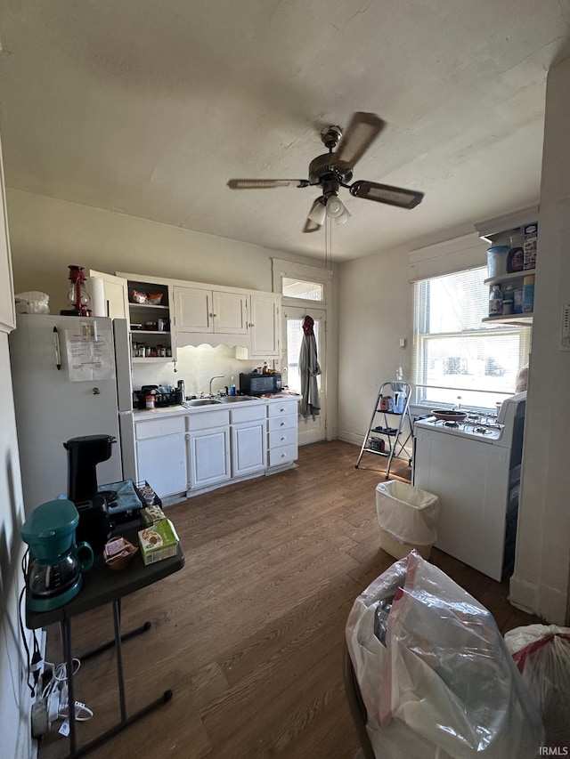 kitchen featuring dark hardwood / wood-style floors, sink, white cabinets, white refrigerator, and ceiling fan