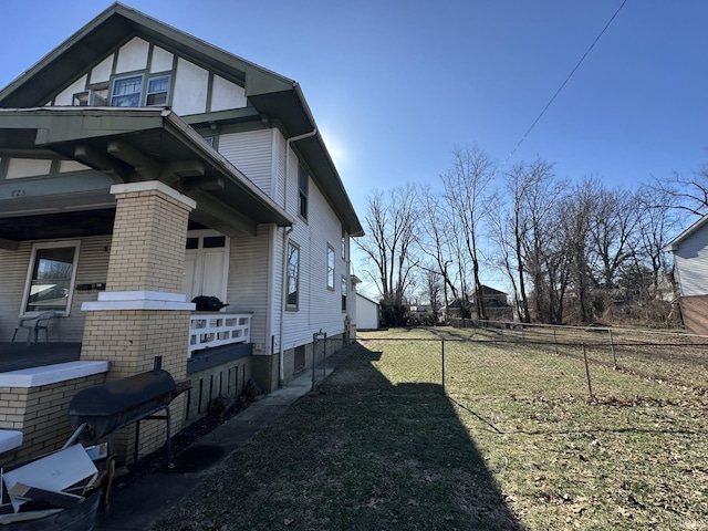 view of side of home with a lawn