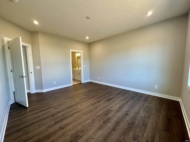 unfurnished room with dark hardwood / wood-style flooring