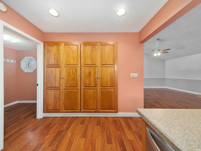 interior space with dark wood-type flooring and ceiling fan