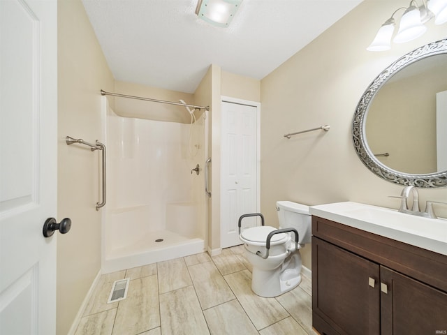 bathroom with a shower, vanity, and toilet