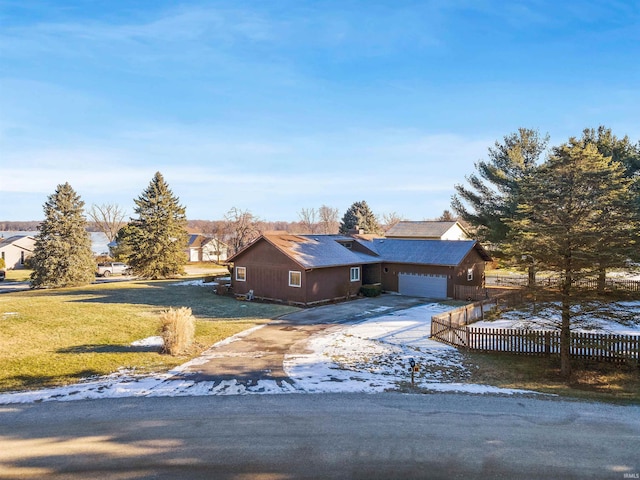 single story home featuring a garage and a front yard