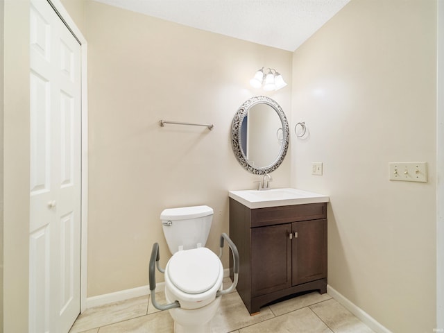 bathroom with vanity, toilet, and tile patterned flooring