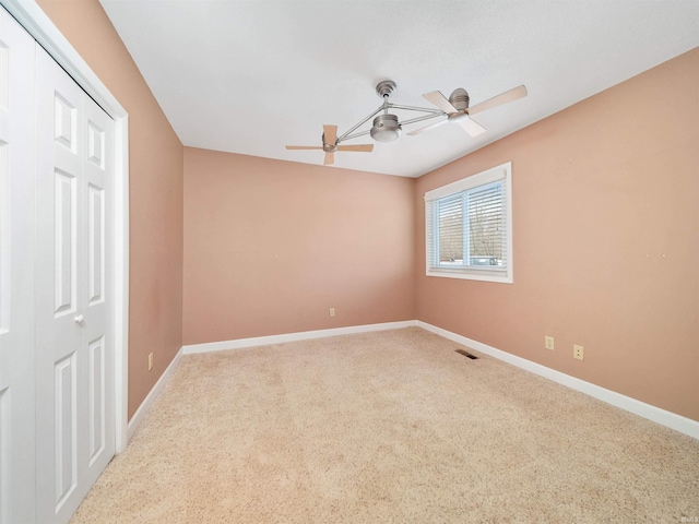 unfurnished room featuring carpet floors and ceiling fan