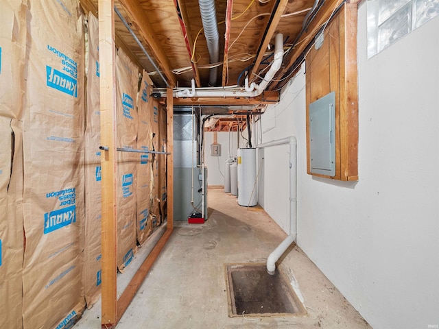 basement with gas water heater, heating unit, and electric panel