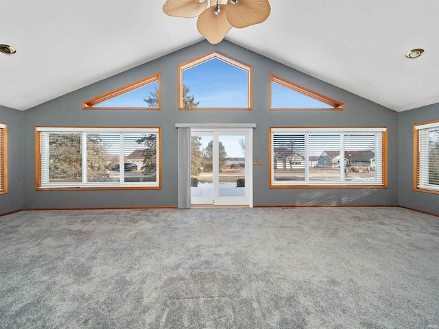 unfurnished living room with vaulted ceiling and carpet