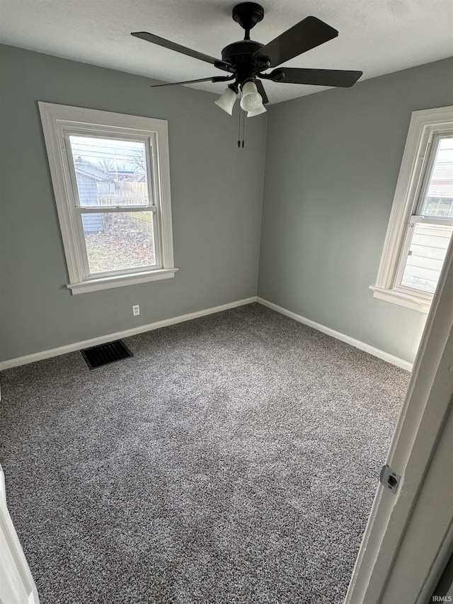 carpeted empty room with ceiling fan and a textured ceiling