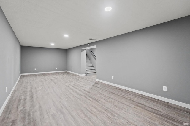 basement with light hardwood / wood-style floors