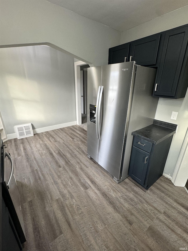 kitchen with stainless steel fridge and light hardwood / wood-style floors