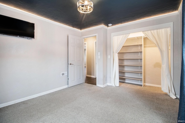 unfurnished bedroom featuring crown molding, carpet flooring, and a closet