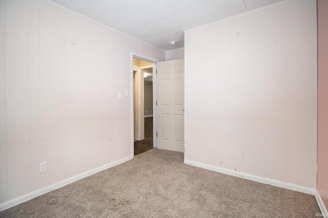 carpeted spare room featuring ornamental molding