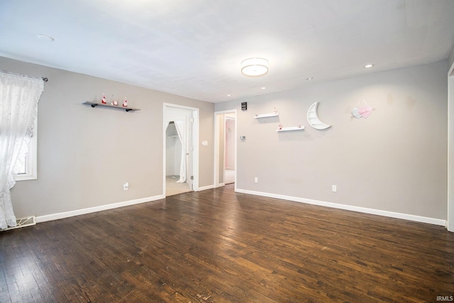 unfurnished room featuring dark wood-type flooring