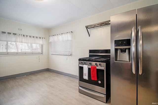 kitchen featuring appliances with stainless steel finishes and light hardwood / wood-style floors