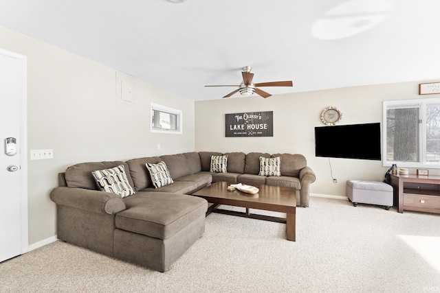 living room featuring ceiling fan and carpet