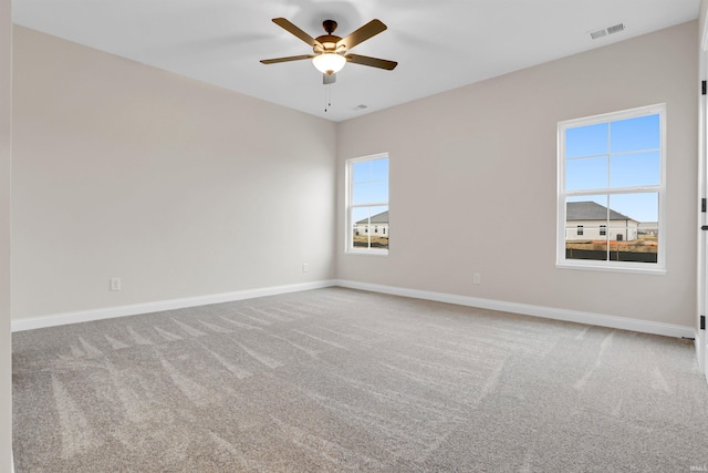 spare room with carpet floors and ceiling fan