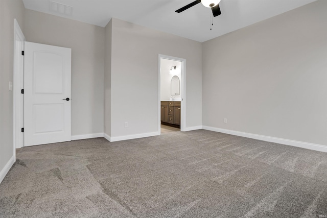 unfurnished bedroom featuring light carpet, ensuite bath, and ceiling fan