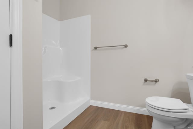 bathroom featuring wood-type flooring and toilet