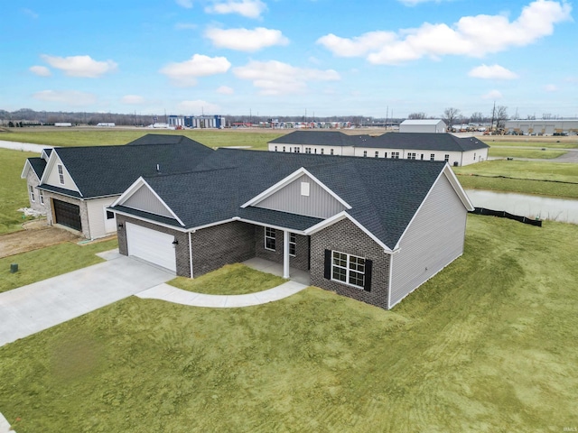 view of front of property featuring a garage and a front lawn