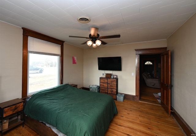 bedroom with ceiling fan and light hardwood / wood-style flooring