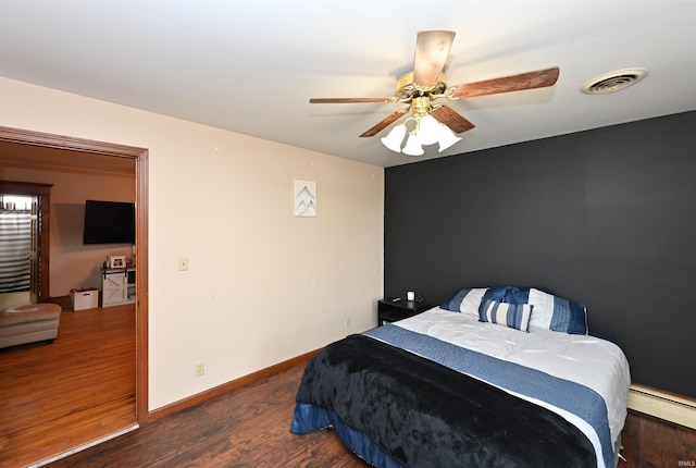 bedroom with a baseboard radiator, dark hardwood / wood-style floors, and ceiling fan