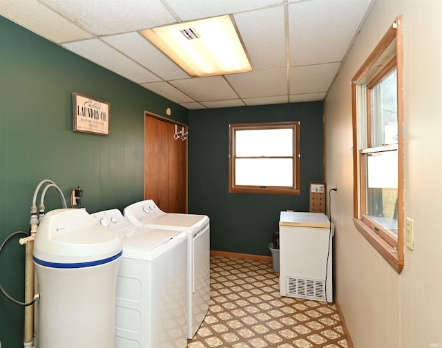 clothes washing area featuring a healthy amount of sunlight and washer and dryer