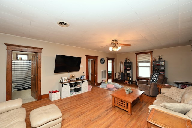 living room with ceiling fan and light wood-type flooring