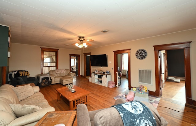 living room with hardwood / wood-style floors and ceiling fan