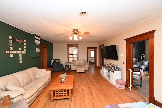 living room featuring ceiling fan and light wood-type flooring