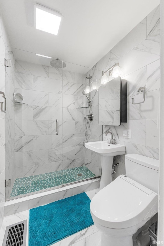 bathroom featuring toilet, tile walls, and walk in shower