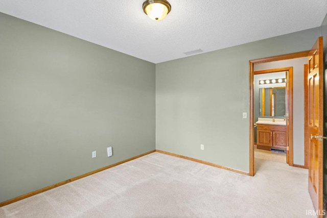 carpeted empty room featuring a textured ceiling