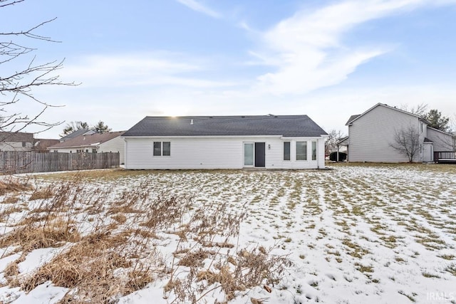 view of snow covered rear of property