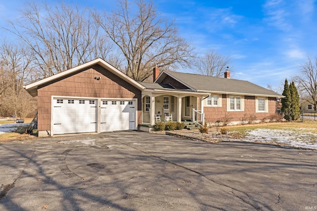 ranch-style home featuring a porch and a garage