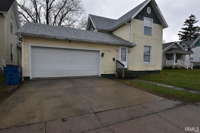 view of front property with a garage and a front lawn