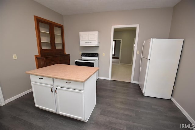 kitchen with dark wood-type flooring, electric range, a kitchen island, white fridge, and white cabinets