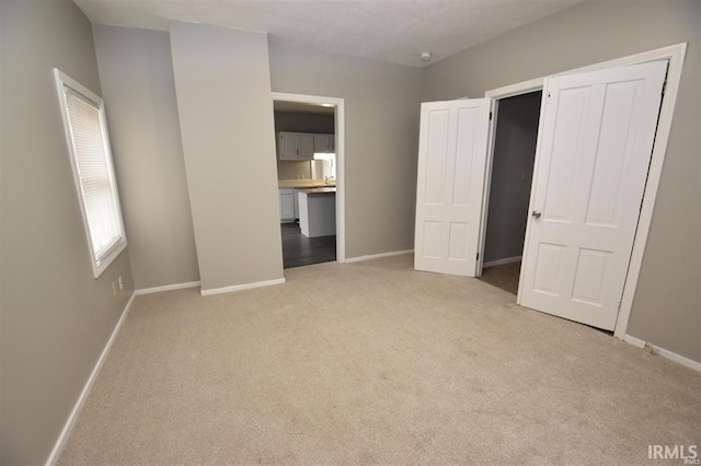 unfurnished bedroom with light colored carpet