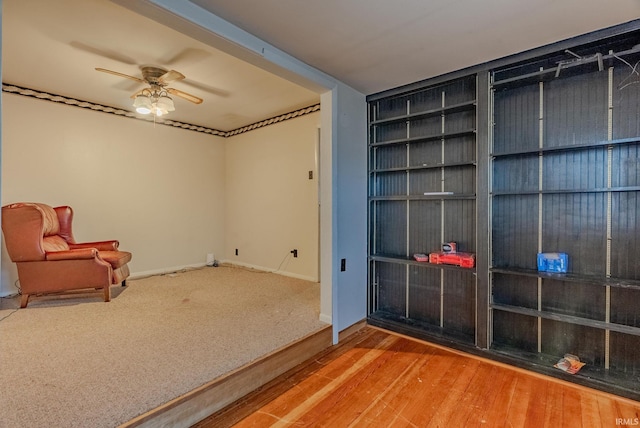 sitting room featuring ceiling fan and hardwood / wood-style floors