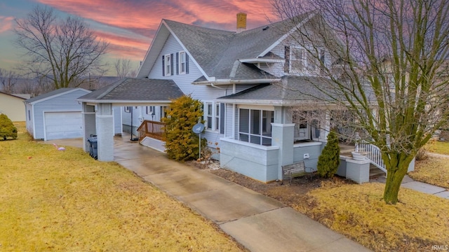 view of front of property with a garage, an outdoor structure, and a yard