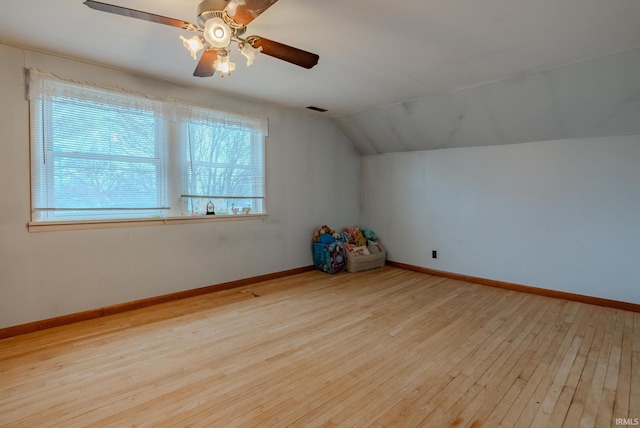 additional living space featuring lofted ceiling and light wood-type flooring