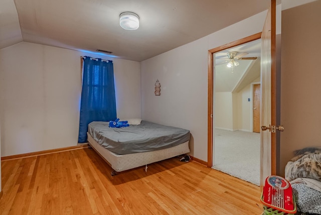 bedroom featuring hardwood / wood-style flooring and vaulted ceiling